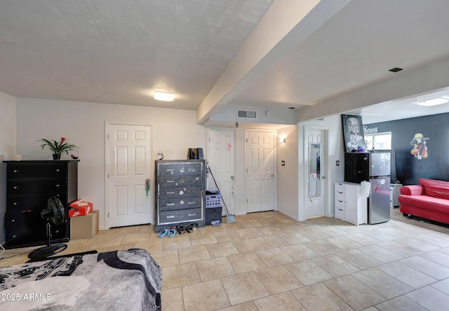 interior space featuring light tile patterned floors and visible vents