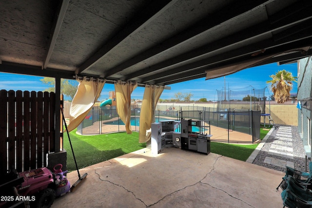 view of patio with a trampoline, a fenced backyard, and a fenced in pool