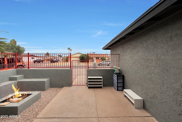 view of patio with an outdoor fire pit