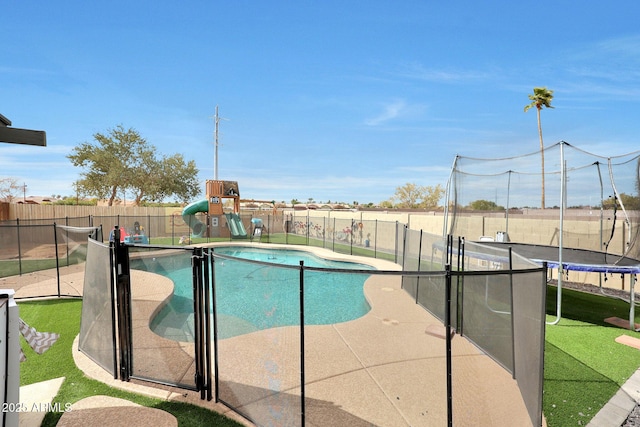 view of pool with a fenced in pool, a fenced backyard, a trampoline, a patio area, and a playground