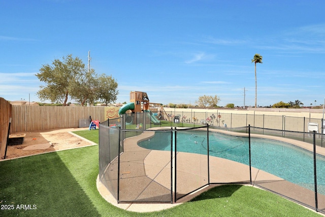 view of pool with a lawn, a playground, a fenced backyard, and a fenced in pool