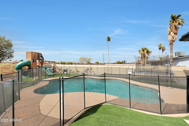 view of pool featuring a fenced in pool, a trampoline, central air condition unit, playground community, and a fenced backyard