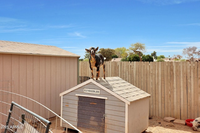 view of shed featuring fence