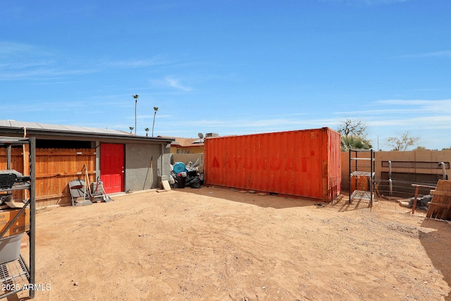 view of yard with fence and an outdoor structure