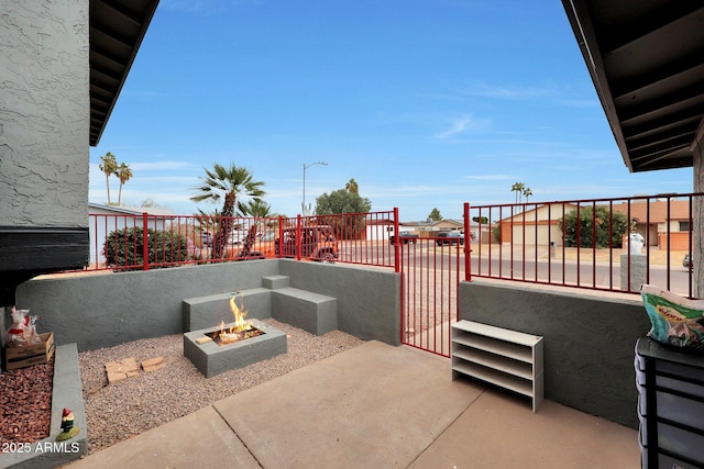 view of patio / terrace featuring a fire pit and a balcony