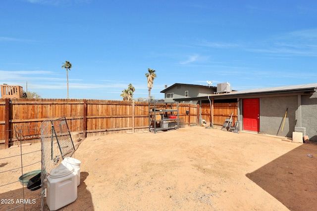 view of yard featuring a fenced backyard and central AC unit