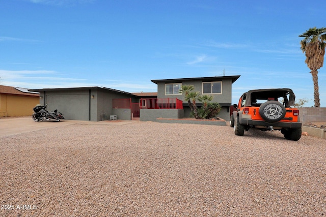 view of front of property with a garage and fence