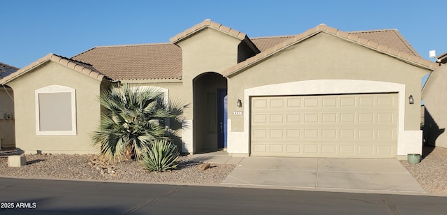 2101 S Meridian Rd Unit 437, Apache Junction, AZ 85120 - mediterranean / spanish-style home featuring a garage, driveway, stucco siding, and a tiled roof