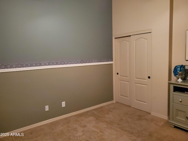 2101 S Meridian Rd Unit 437, Apache Junction, AZ 85120 - unfurnished bedroom featuring light colored carpet, a closet, and baseboards