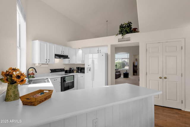 kitchen featuring a sink, white fridge with ice dispenser, range with electric cooktop, and light countertops