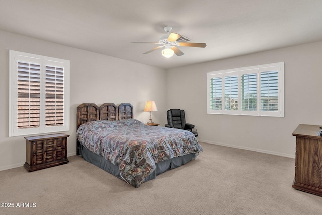 bedroom with baseboards, ceiling fan, and light colored carpet