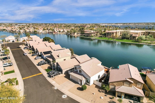 drone / aerial view with a water view and a residential view