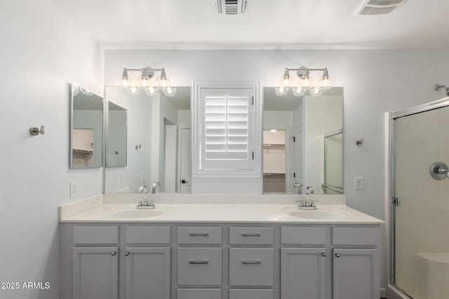 full bathroom featuring a sink, visible vents, and a shower stall