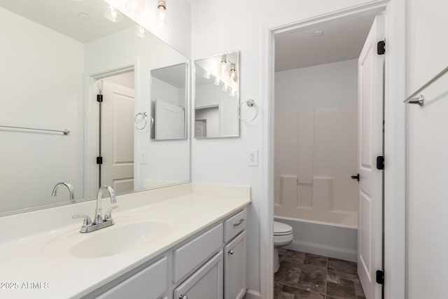 bathroom featuring tub / shower combination, vanity, and toilet