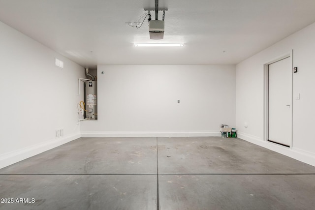 3555 E Erie St, Gilbert, AZ 85295 - garage featuring a garage door opener, gas water heater, and baseboards
