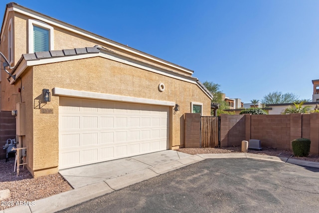 3555 E Erie St, Gilbert, AZ 85295 - view of side of property featuring driveway, fence, and stucco siding