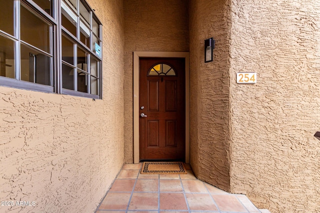 property entrance featuring stucco siding