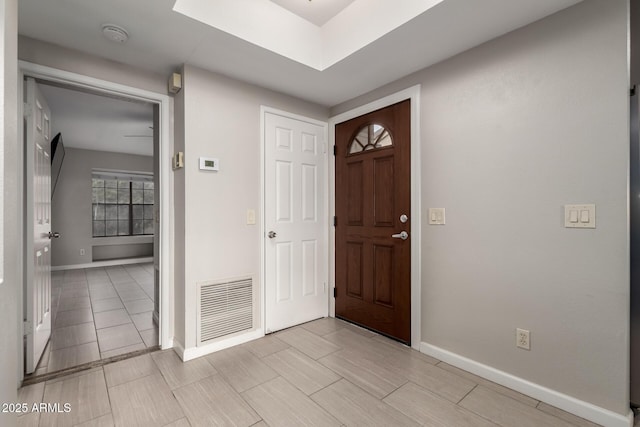 entrance foyer featuring baseboards and visible vents