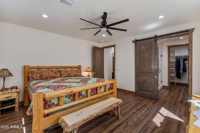 2380 W Narrow Leaf Ln, Show Low, AZ 85901 - bedroom featuring a barn door, wood finished floors, recessed lighting, a spacious closet, and baseboards