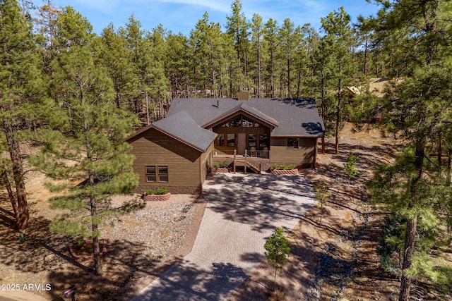 2380 W Narrow Leaf Ln, Show Low, AZ 85901 - chalet / cabin featuring a chimney, a wooden deck, driveway, and a forest view