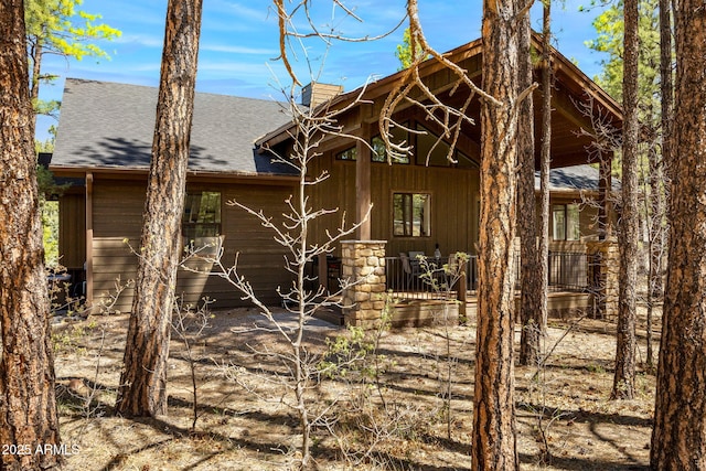 2380 W Narrow Leaf Ln, Show Low, AZ 85901 - rear view of property with covered porch, a shingled roof, and a chimney