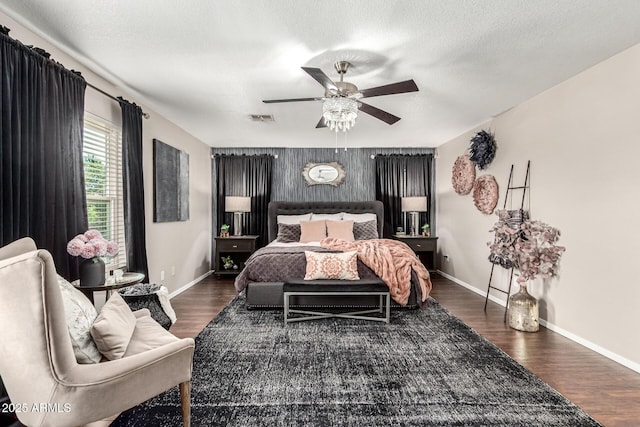5110 E Mark Ln, Cave Creek, AZ 85331 - bedroom featuring an accent wall, baseboards, wood finished floors, and a ceiling fan