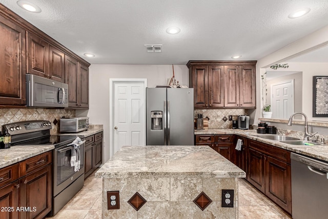 5110 E Mark Ln, Cave Creek, AZ 85331 - kitchen with stainless steel appliances, a sink, backsplash, recessed lighting, and dark brown cabinetry