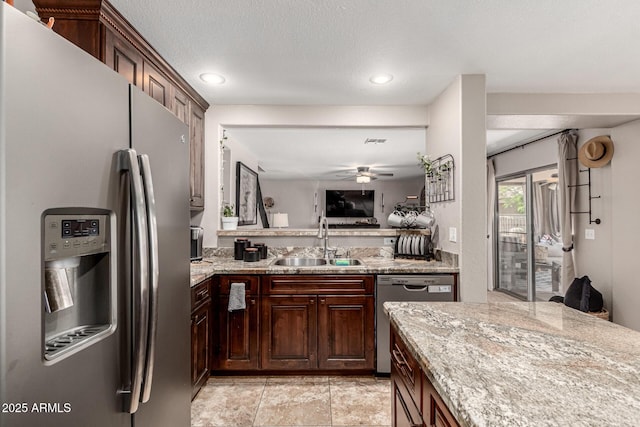 5110 E Mark Ln, Cave Creek, AZ 85331 - kitchen with stainless steel appliances, a sink, a ceiling fan, light stone countertops, and recessed lighting
