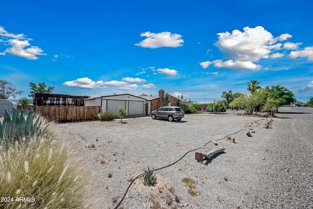 exterior space with a garage and an outbuilding