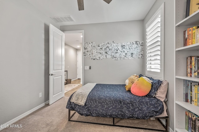 carpeted bedroom featuring ceiling fan, baseboards, multiple windows, and visible vents