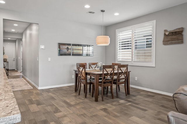 dining area featuring baseboards, wood finished floors, visible vents, and recessed lighting