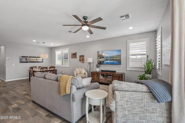 living area with ceiling fan, visible vents, and recessed lighting