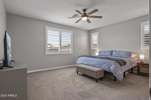 carpeted bedroom with visible vents, baseboards, and ceiling fan