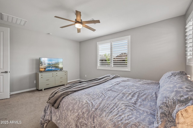 carpeted bedroom with visible vents, a ceiling fan, and baseboards