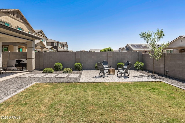 view of yard featuring a patio area, a fenced backyard, and a residential view
