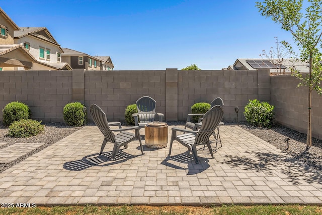 view of patio / terrace with a fenced backyard and an outdoor fire pit