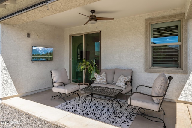view of patio featuring a ceiling fan and an outdoor living space