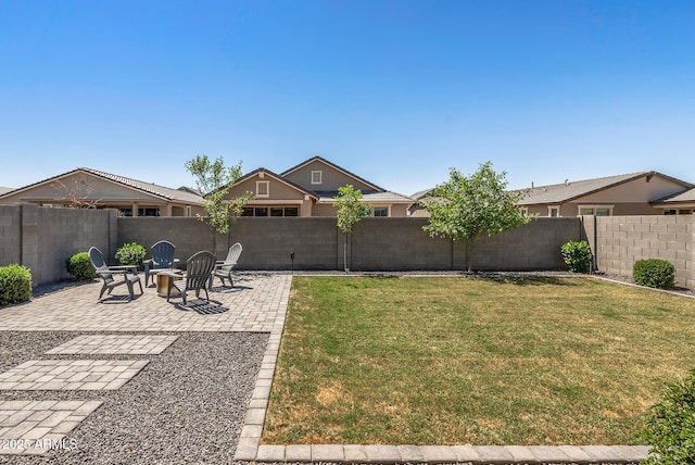 view of yard featuring a fire pit, a fenced backyard, and a patio
