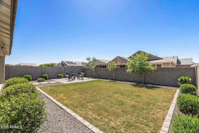 view of yard with a patio area and a fenced backyard