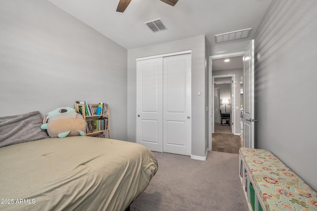 bedroom with a ceiling fan, carpet flooring, visible vents, and a closet