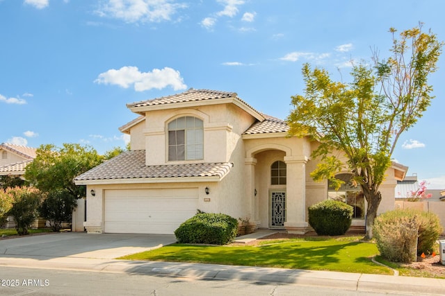 mediterranean / spanish-style house with a garage