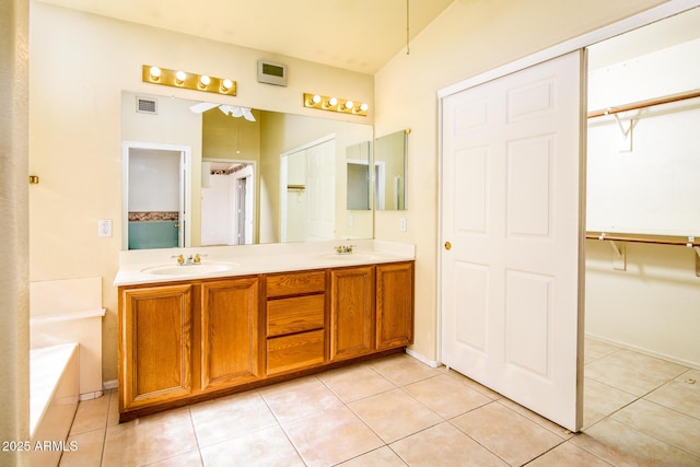 bathroom featuring vanity, a bathing tub, and tile patterned flooring