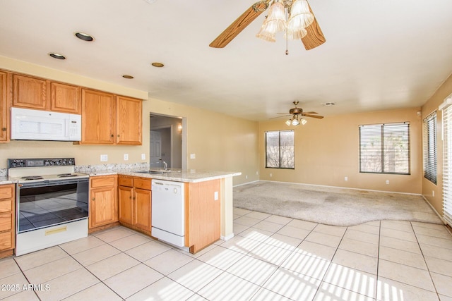 kitchen featuring ceiling fan, light tile patterned floors, white appliances, and kitchen peninsula