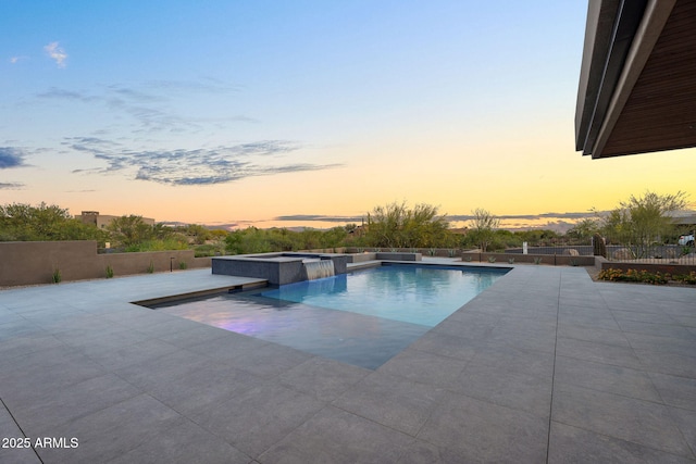 10354 E Celestial Dr, Scottsdale, AZ 85262 - pool at dusk with a patio area, a pool with connected hot tub, and fence
