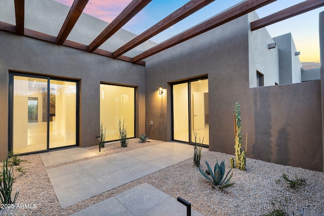 10354 E Celestial Dr, Scottsdale, AZ 85262 - back of property at dusk with stucco siding and a patio area