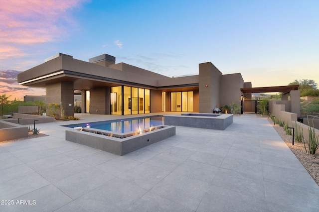 10354 E Celestial Dr, Scottsdale, AZ 85262 - pool at dusk featuring a patio, fence, and a pool with connected hot tub