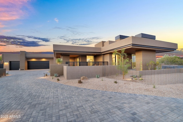10354 E Celestial Dr, Scottsdale, AZ 85262 - contemporary home with stucco siding, a fenced front yard, a garage, and decorative driveway