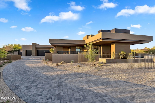 10354 E Celestial Dr, Scottsdale, AZ 85262 - modern home with stucco siding, a fenced front yard, and decorative driveway