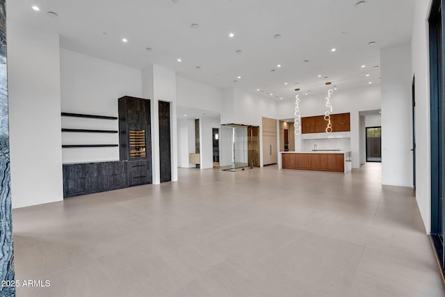 10354 E Celestial Dr, Scottsdale, AZ 85262 - unfurnished living room featuring a towering ceiling and recessed lighting