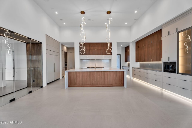 10354 E Celestial Dr, Scottsdale, AZ 85262 - kitchen with modern cabinets, light countertops, a high ceiling, recessed lighting, and a large island